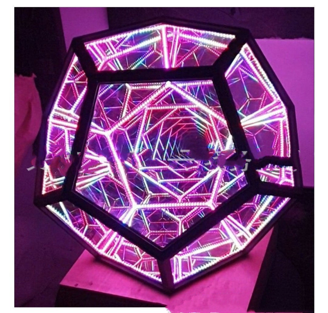 A vibrant Infinite Dodecahedron Color Table Lamp showcasing a 12-sided geometric design with colorful LED lights illuminating its acrylic and plastic frame.