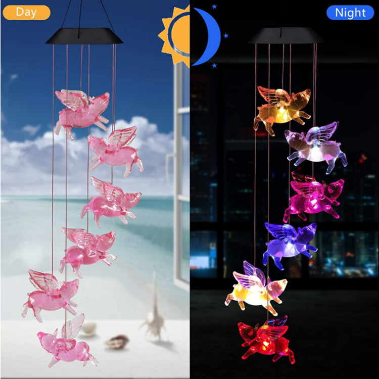 Outdoor Solar Wind Chime Lamp with hummingbird and butterfly designs, glowing softly at night.