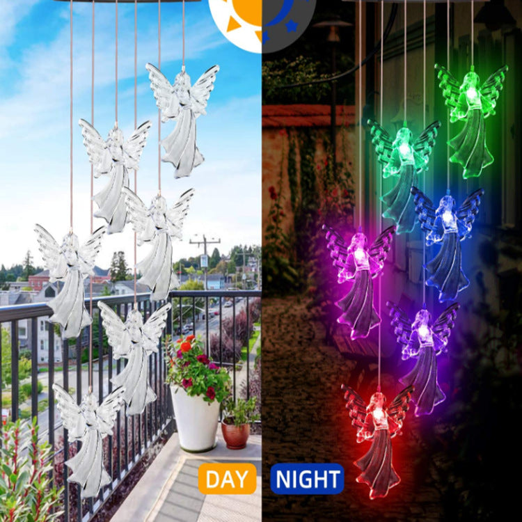 Outdoor Solar Wind Chime Lamp with hummingbird and butterfly designs, glowing softly at night.