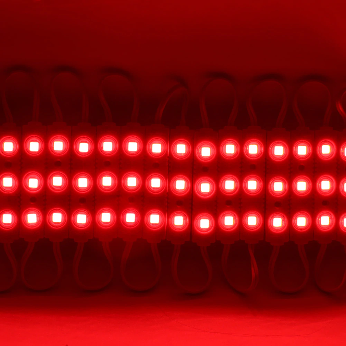SMD LED Red Injection Module IP67 DC12V Strip with self-adhesive backing, showcasing its compact design and bright red illumination.