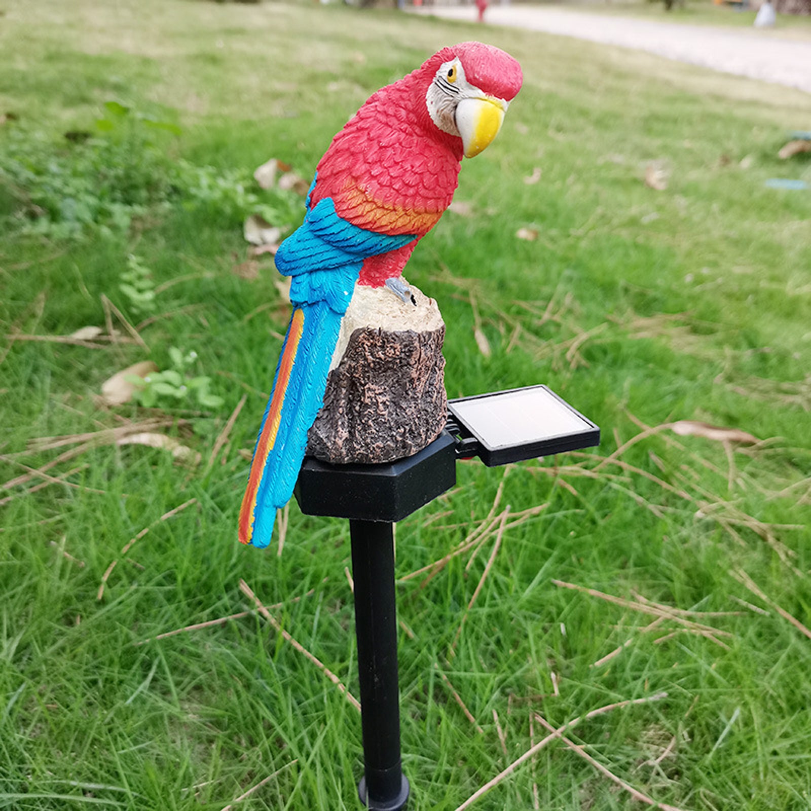 Solar Parrot Light LED Outdoor Decor Lamp featuring a lifelike parrot sculpture on a stake, illuminating the garden with a warm glow.