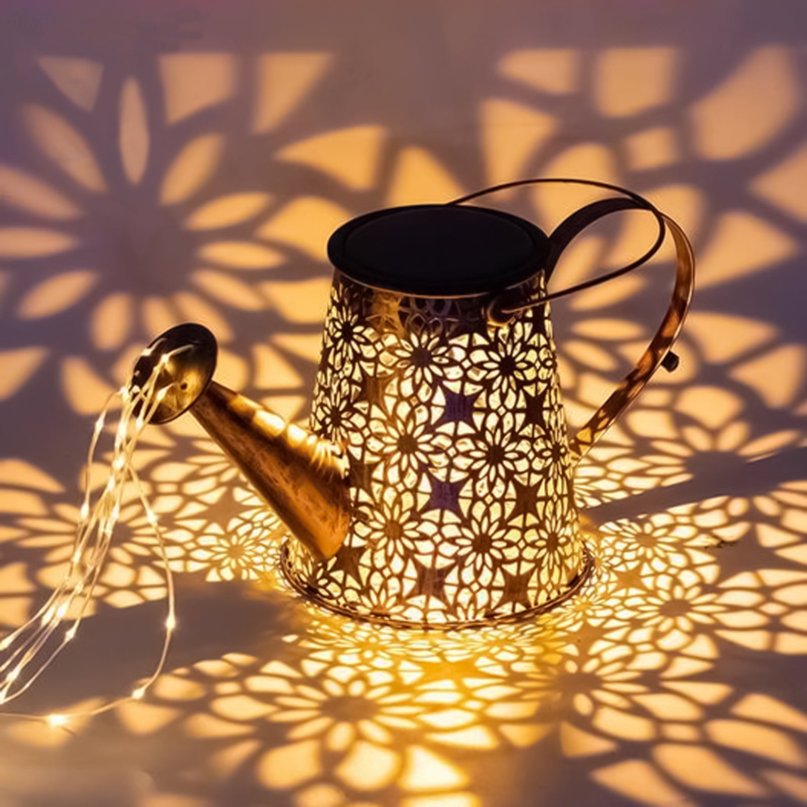 A decorative solar watering can light with LED string lights, hanging on a shepherd hook, illuminating a garden with beautiful patterns.