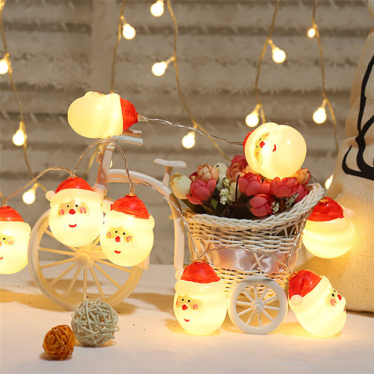 Colorful LED string lights in festive designs, perfect for Christmas and New Year decorations, illuminating a cozy outdoor setting.