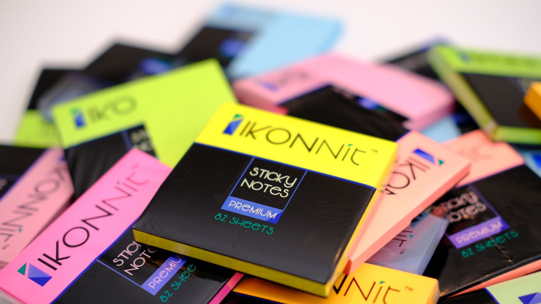 An 8 pack of 3x3 bright color self-stick sticky notes in various vibrant shades including pink, blue, yellow, green, orange, magenta, and purple, displayed in a compact box.