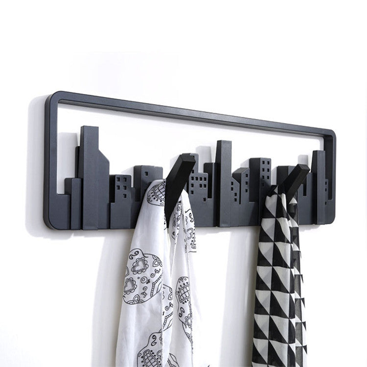 Stylish black wall-mounted coat rack with five flip-down hooks for versatile storage.