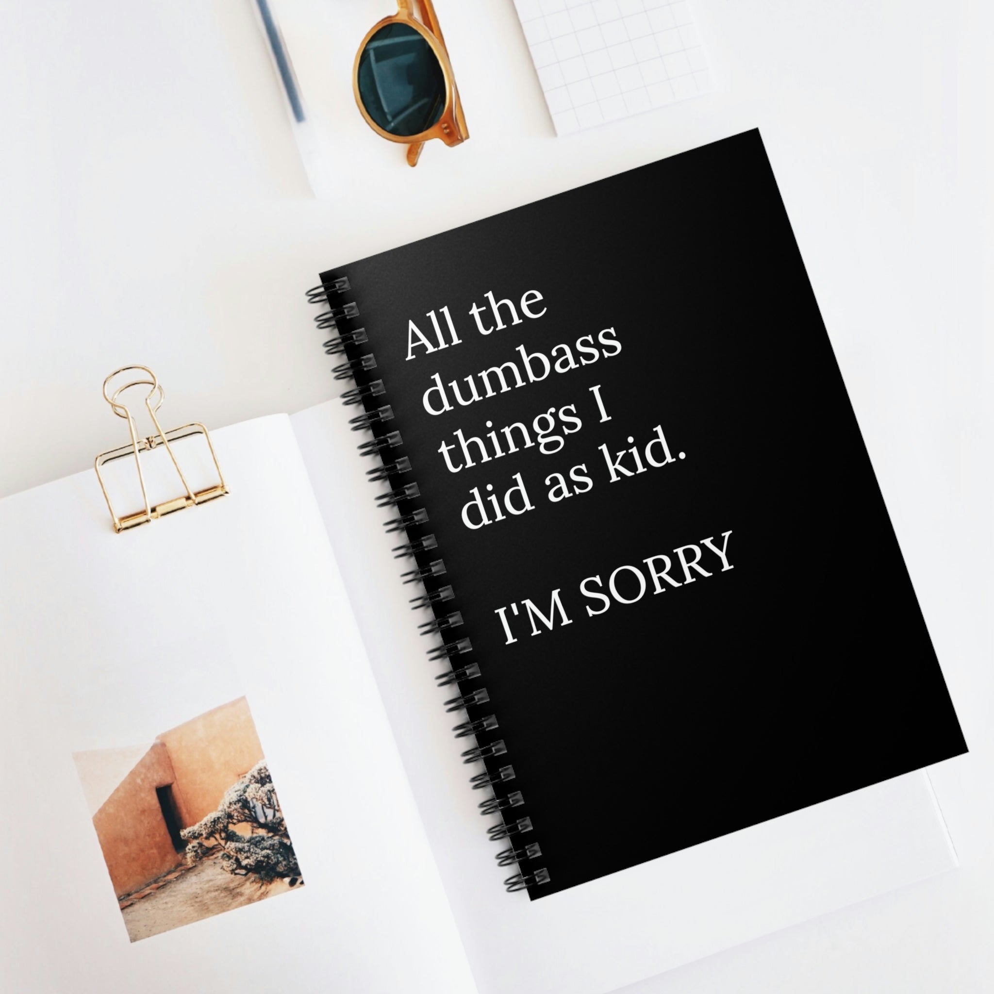 A humorous spiral notebook with a funny cover about childhood antics, featuring ruled line pages and a durable design.