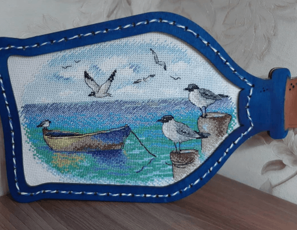 At the Pier M-557 / SM-557 Counted Cross-Stitch Kit featuring Aida canvas, colorful threads, and detailed instructions for crafting.