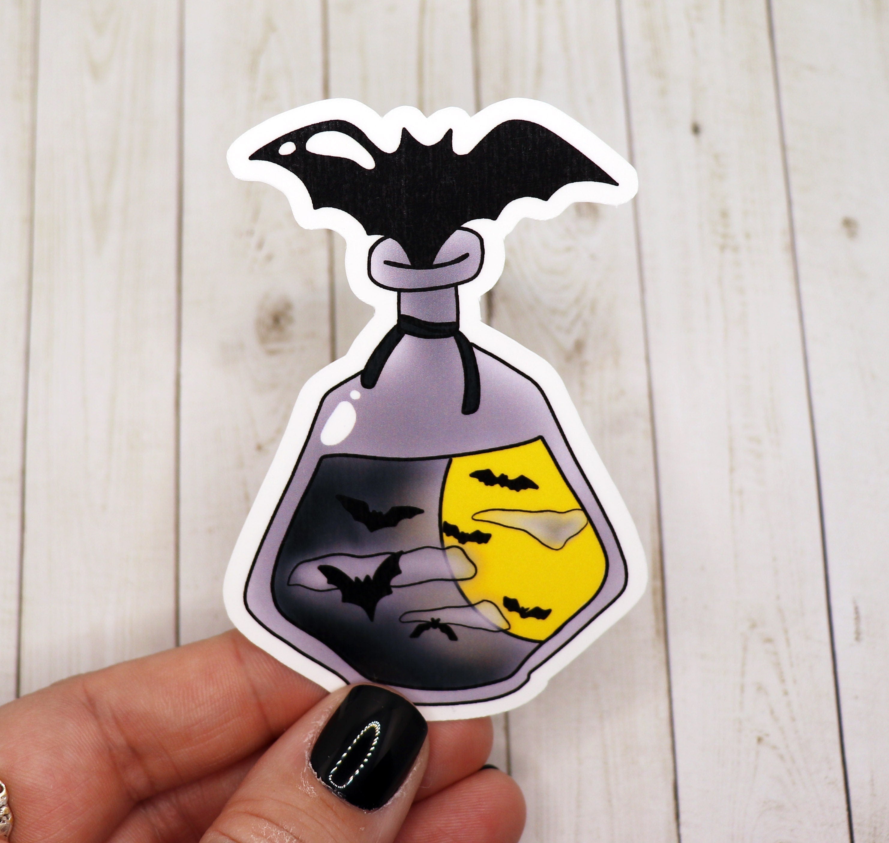 Black Bat Potion Bottle Sticker on a white background, showcasing its intricate design and matte finish.