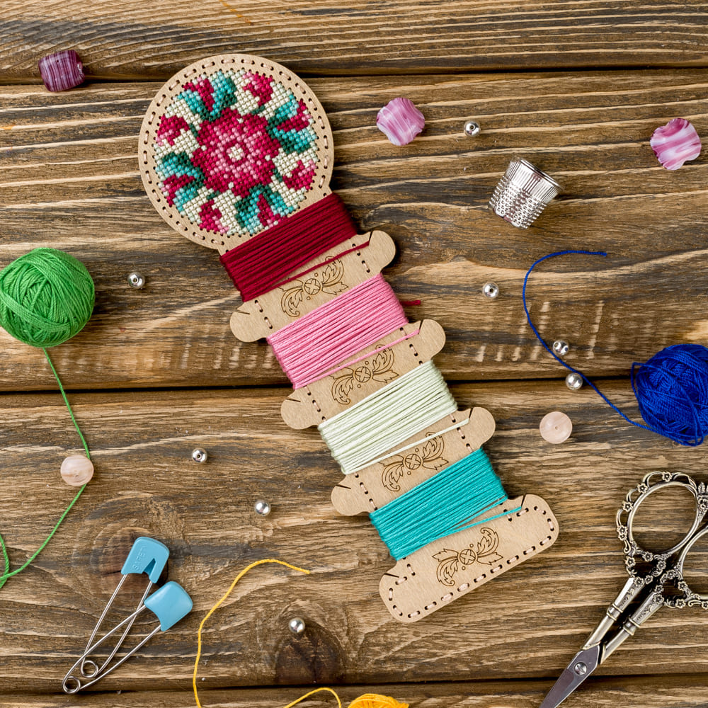 Wooden embroidery blank FLHW-005 with perforated design for thread embroidery, includes thread, needle, and instructions.