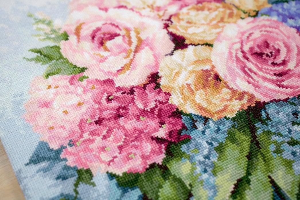 Bouquet B2371L Counted Cross-Stitch Kit featuring pink roses, yellow peonies, and blue pansies on Aida canvas.