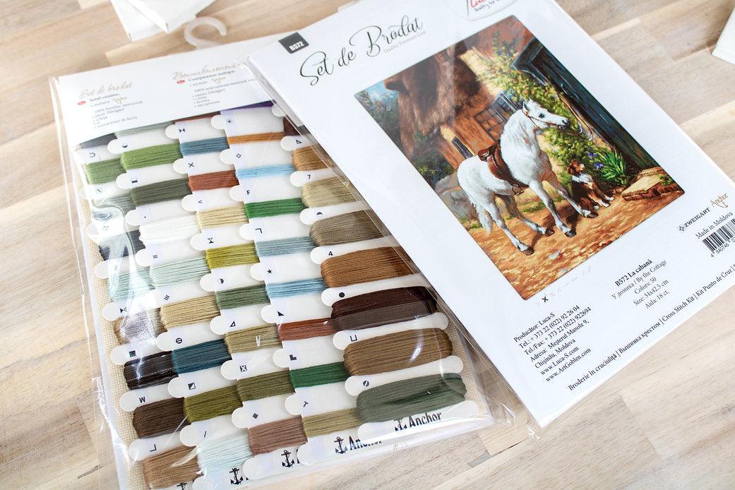 By the Cottage B572L Counted Cross-Stitch Kit featuring Aida canvas, 50 Anchor colors, and needle for crafting.