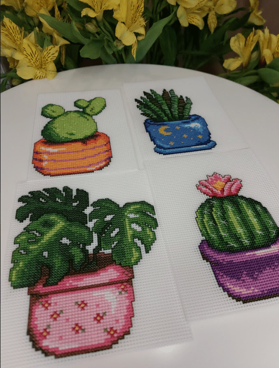 Cactus 108CS Counted Cross-Stitch Kit featuring plastic canvas, colorful threads, and a needle for crafting.
