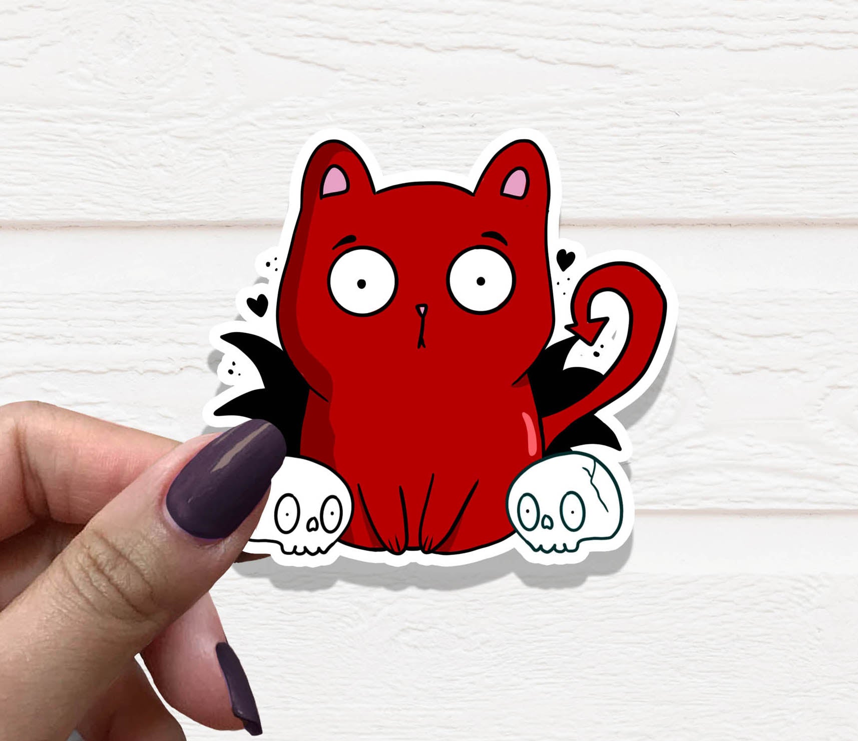 A vibrant Cat Devil Vinyl Sticker featuring a playful cat design, perfect for personalizing various items.