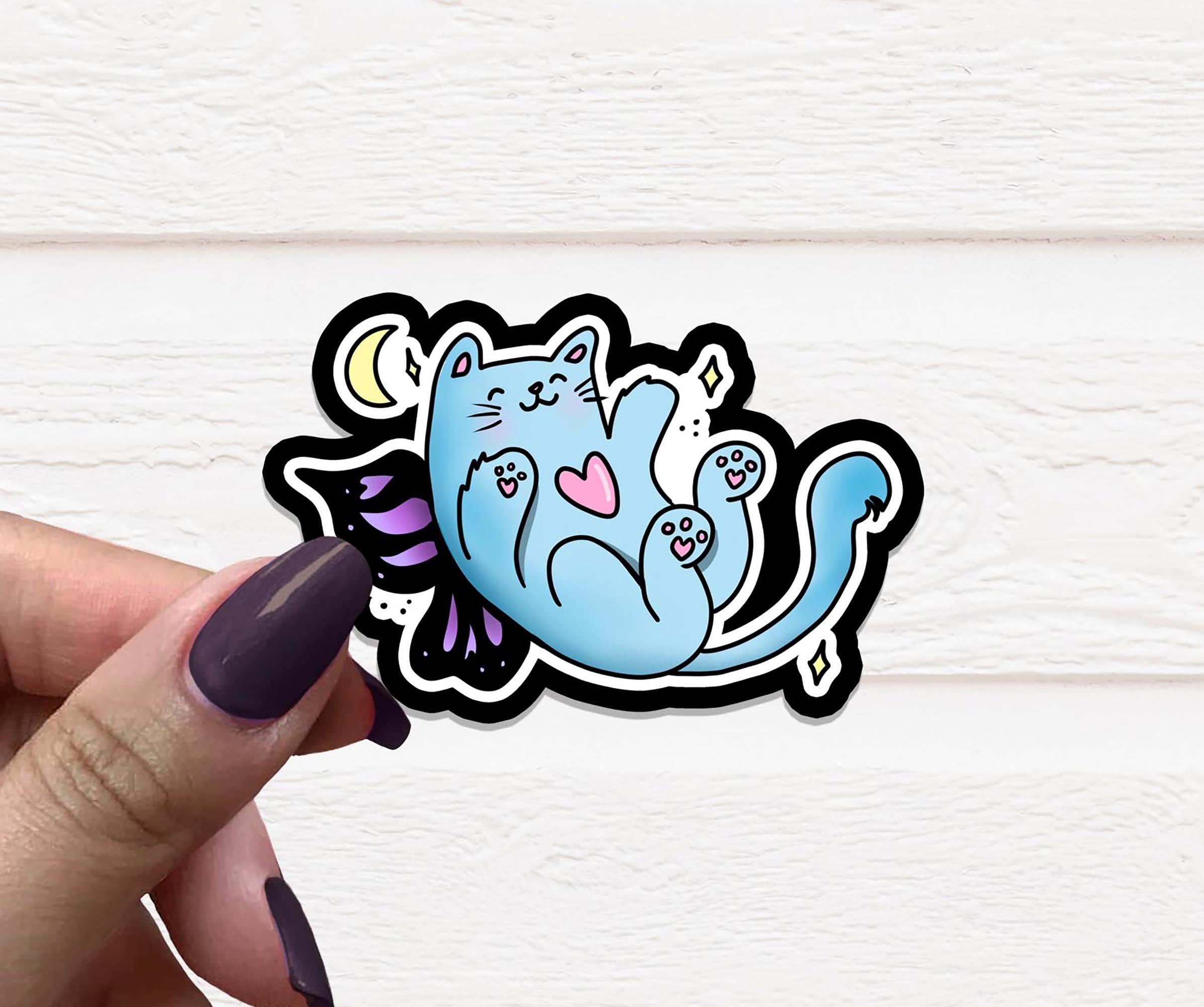 A whimsical Cat Fairy Vinyl Sticker featuring a playful cat with fairy wings, perfect for personalizing various items.