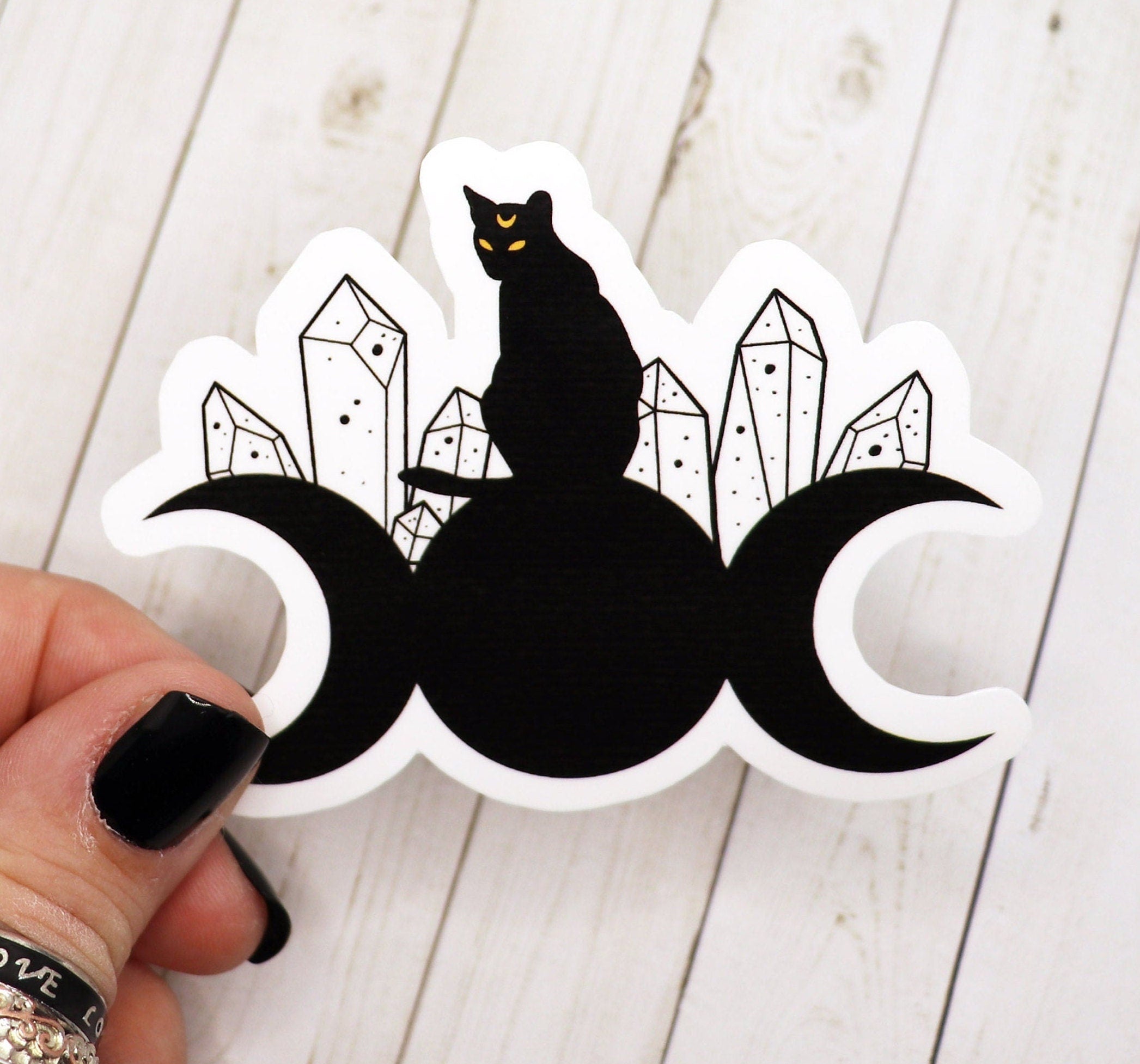 A whimsical Cat on Moon sticker featuring a cute cat sitting on a crescent moon, designed for various surfaces.