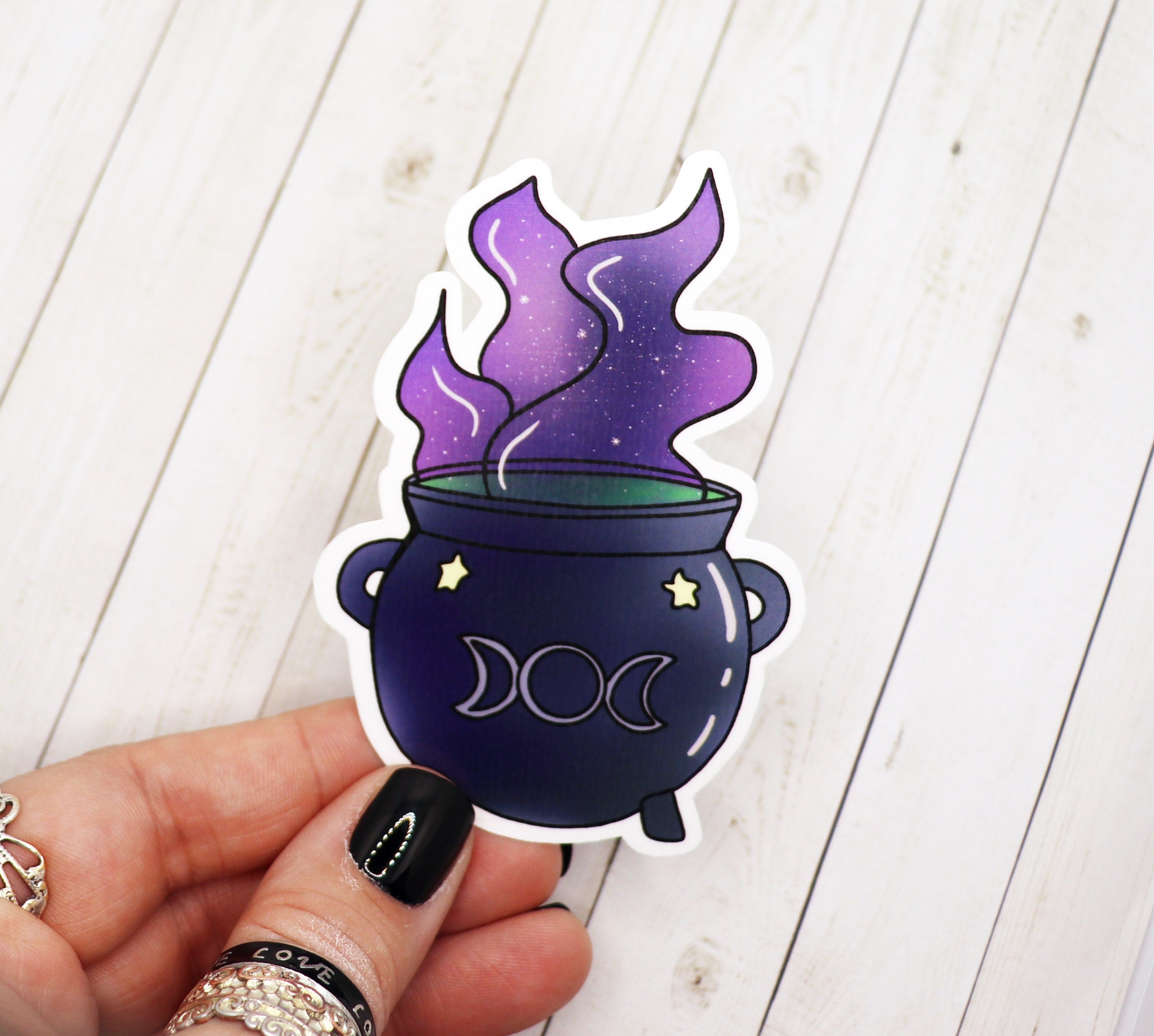 A vibrant cauldron sticker featuring a magical design, perfect for personalizing various items.