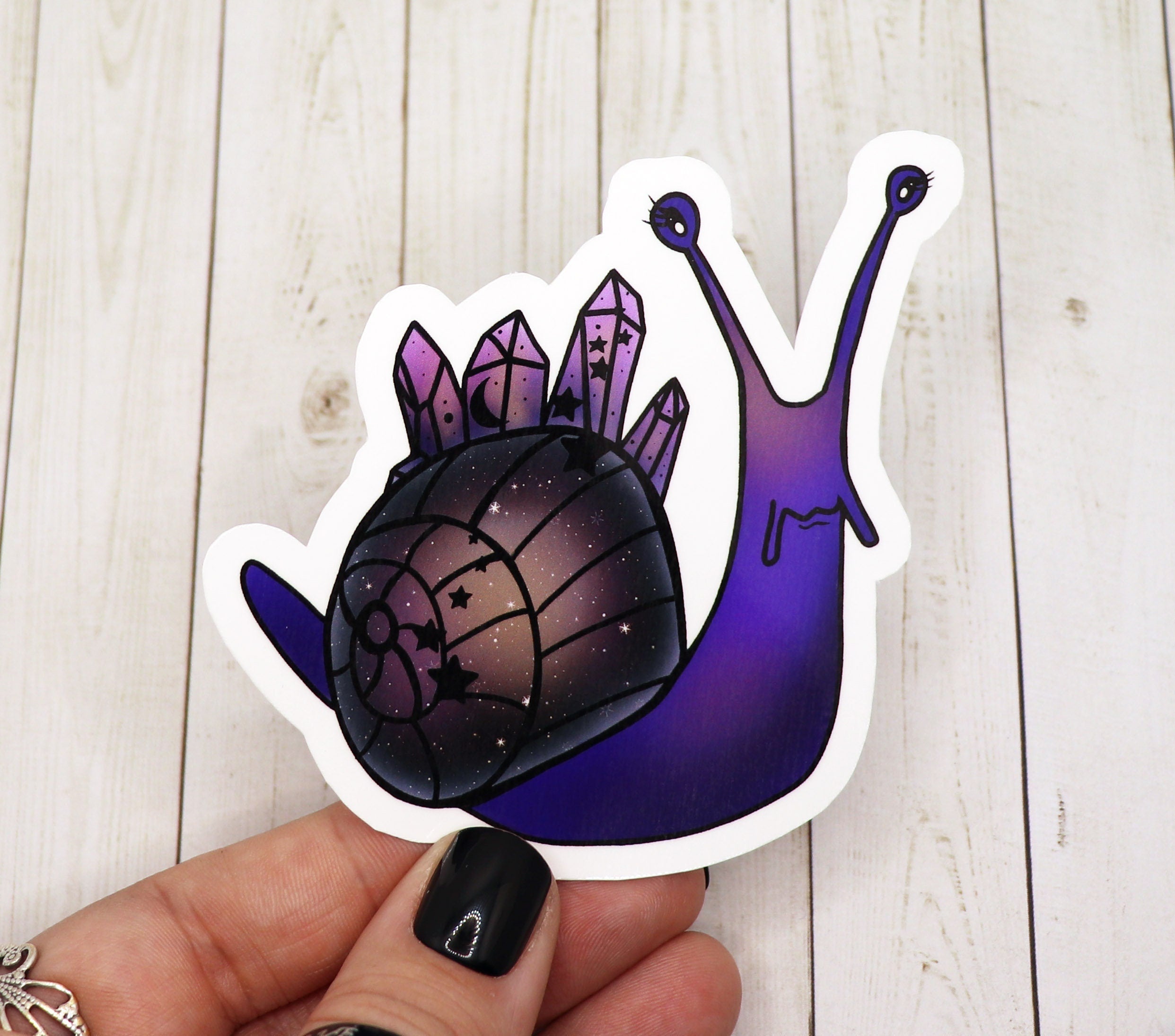 A vibrant celestial snail sticker featuring intricate cosmic designs on a matte finish.