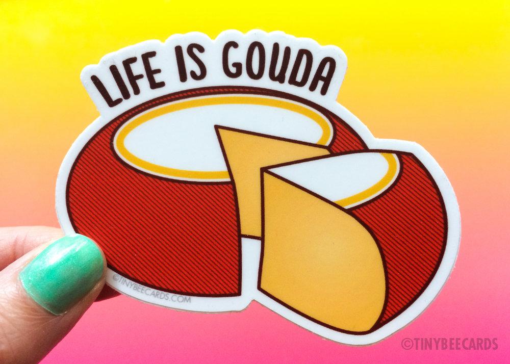 Cheese Lover Vinyl Sticker featuring a gouda cheese wheel and the text 'Life is Gouda', perfect for personalizing items.