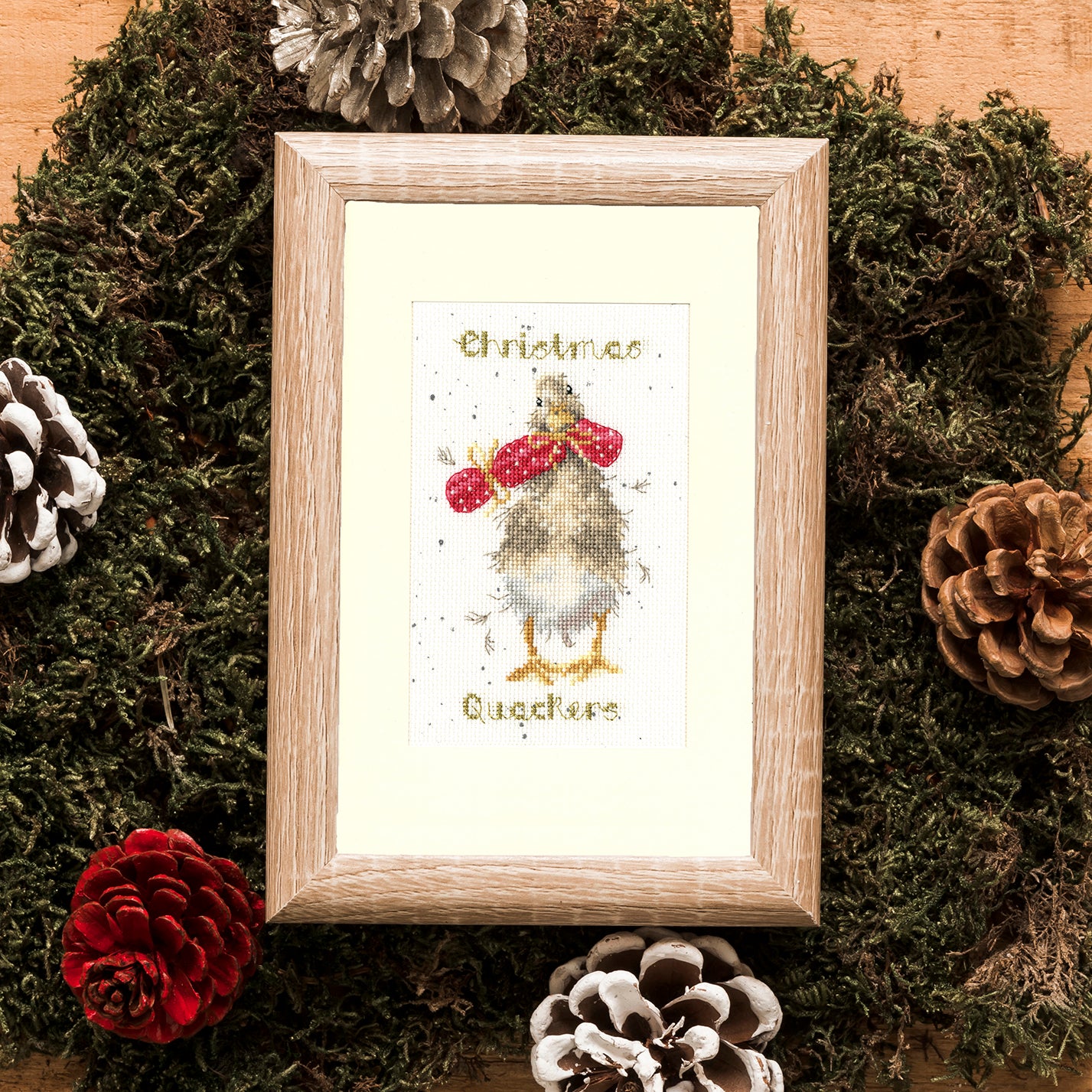 Christmas Quackers XMAS48 Counted Cross Stitch Kit with materials and finished card design.
