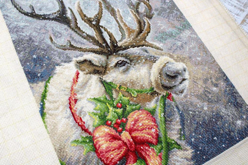 Christmas Deer B598L Counted Cross-Stitch Kit featuring Aida canvas, colorful threads, and a needle for festive crafting.