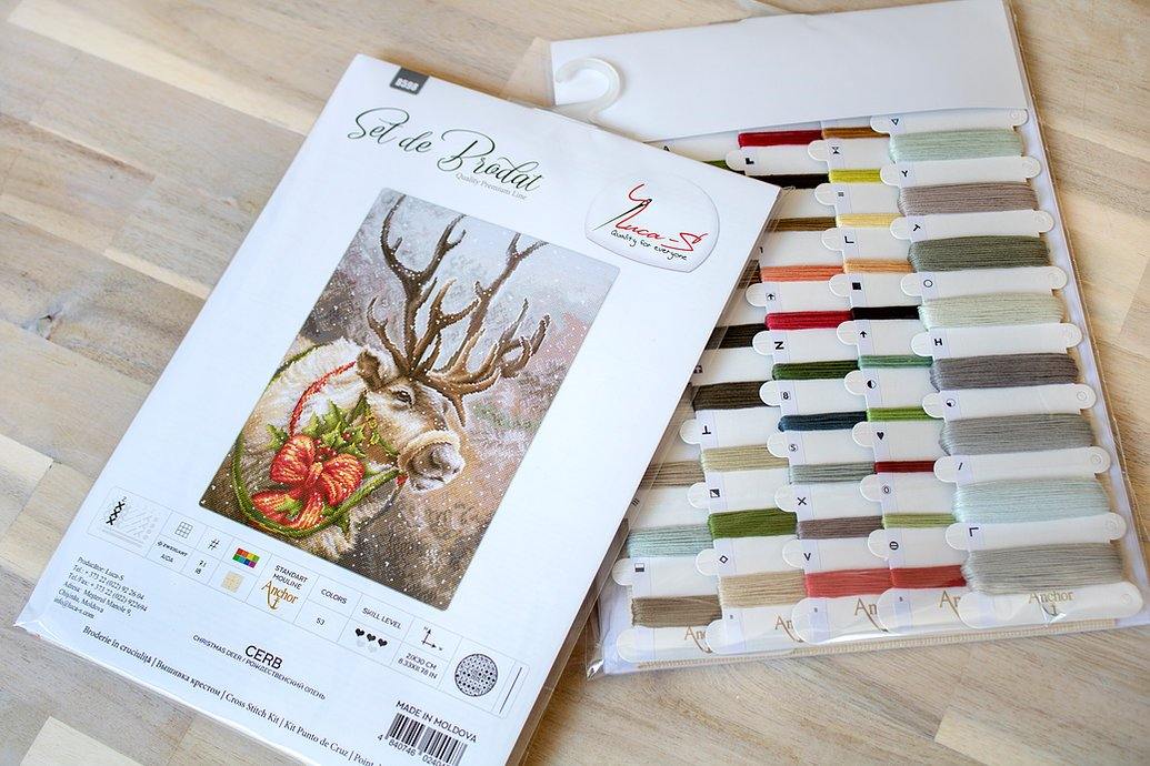 Christmas Deer B598L Counted Cross-Stitch Kit featuring Aida canvas, colorful threads, and a needle for festive crafting.