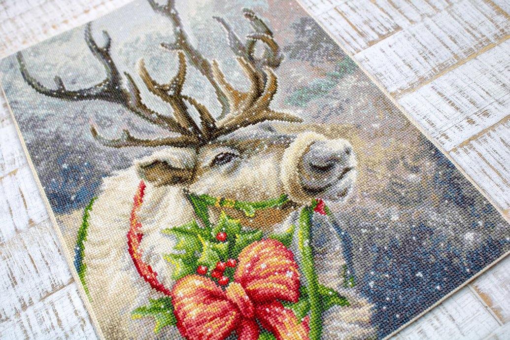 Christmas Deer B598L Counted Cross-Stitch Kit featuring Aida canvas, colorful threads, and a needle for festive crafting.