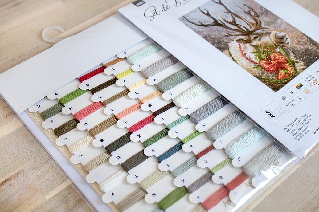 Christmas Deer B598L Counted Cross-Stitch Kit featuring Aida canvas, colorful threads, and a needle for festive crafting.