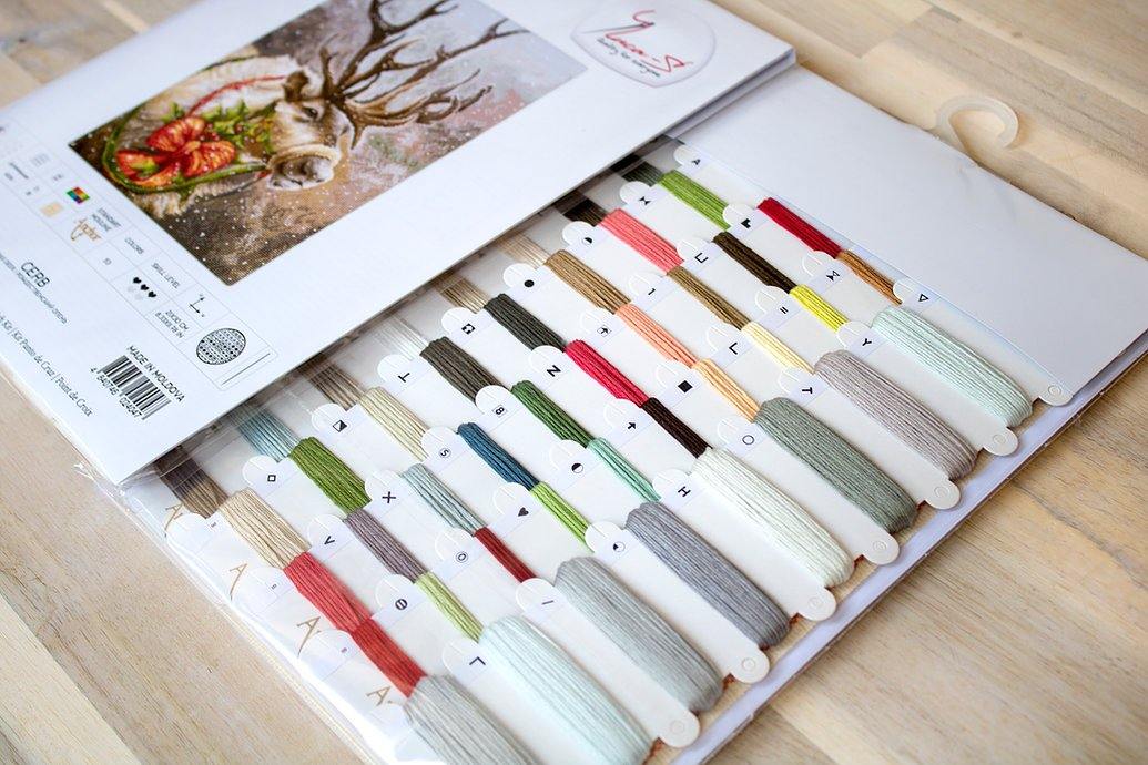 Christmas Deer B598L Counted Cross-Stitch Kit featuring Aida canvas, colorful threads, and a needle for festive crafting.