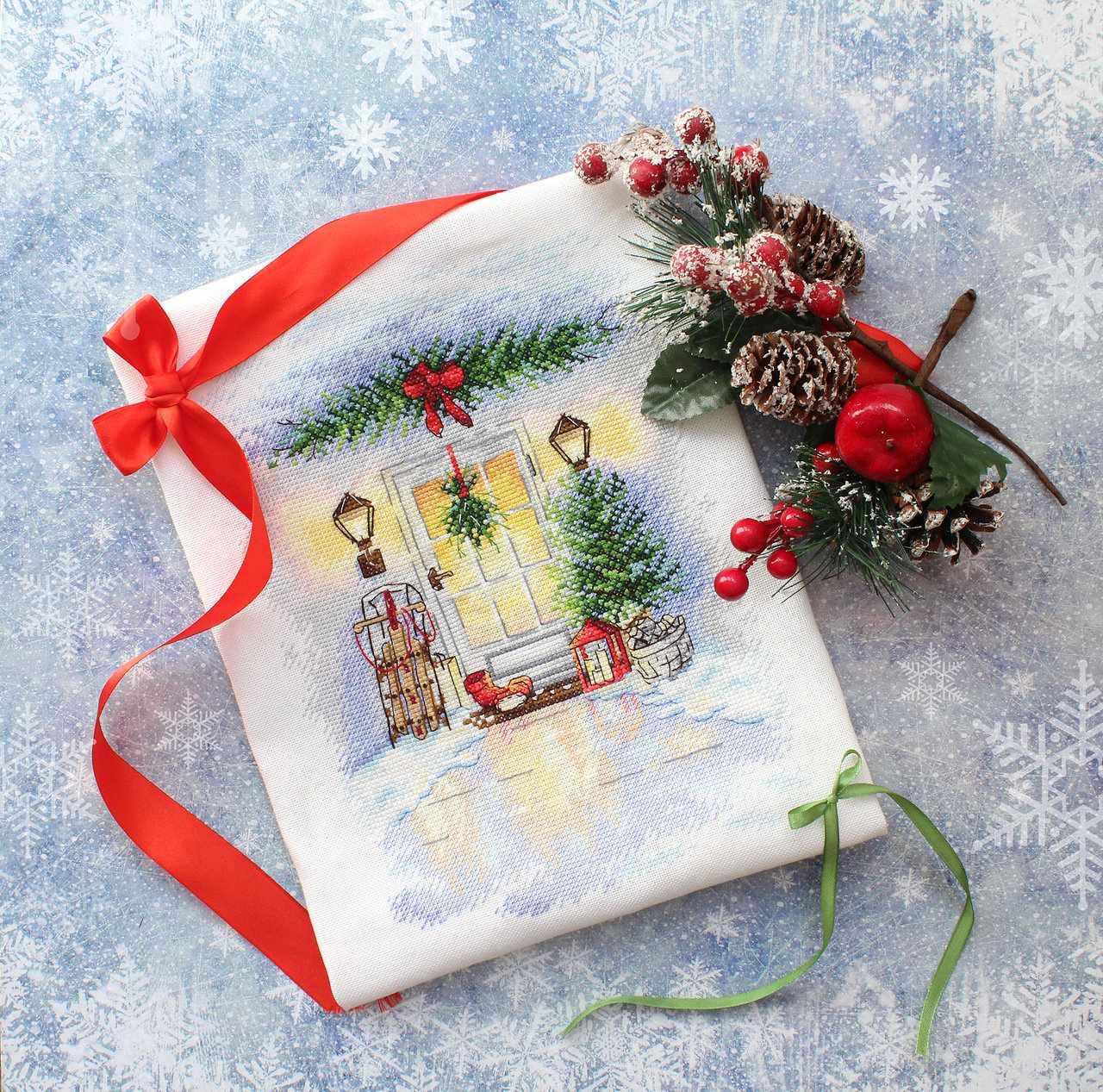 Christmas Door Cross Stitch Kit featuring a festive door design with pine decorations and sledges, perfect for winter crafting.