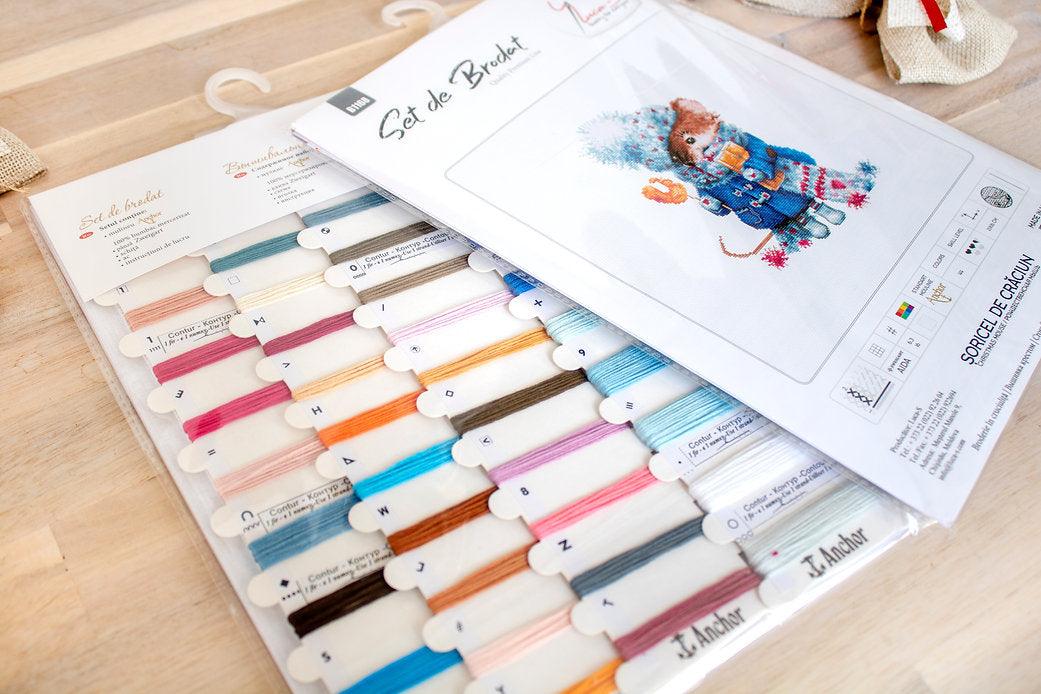 Christmas mouse counted cross-stitch kit with colorful threads and canvas.