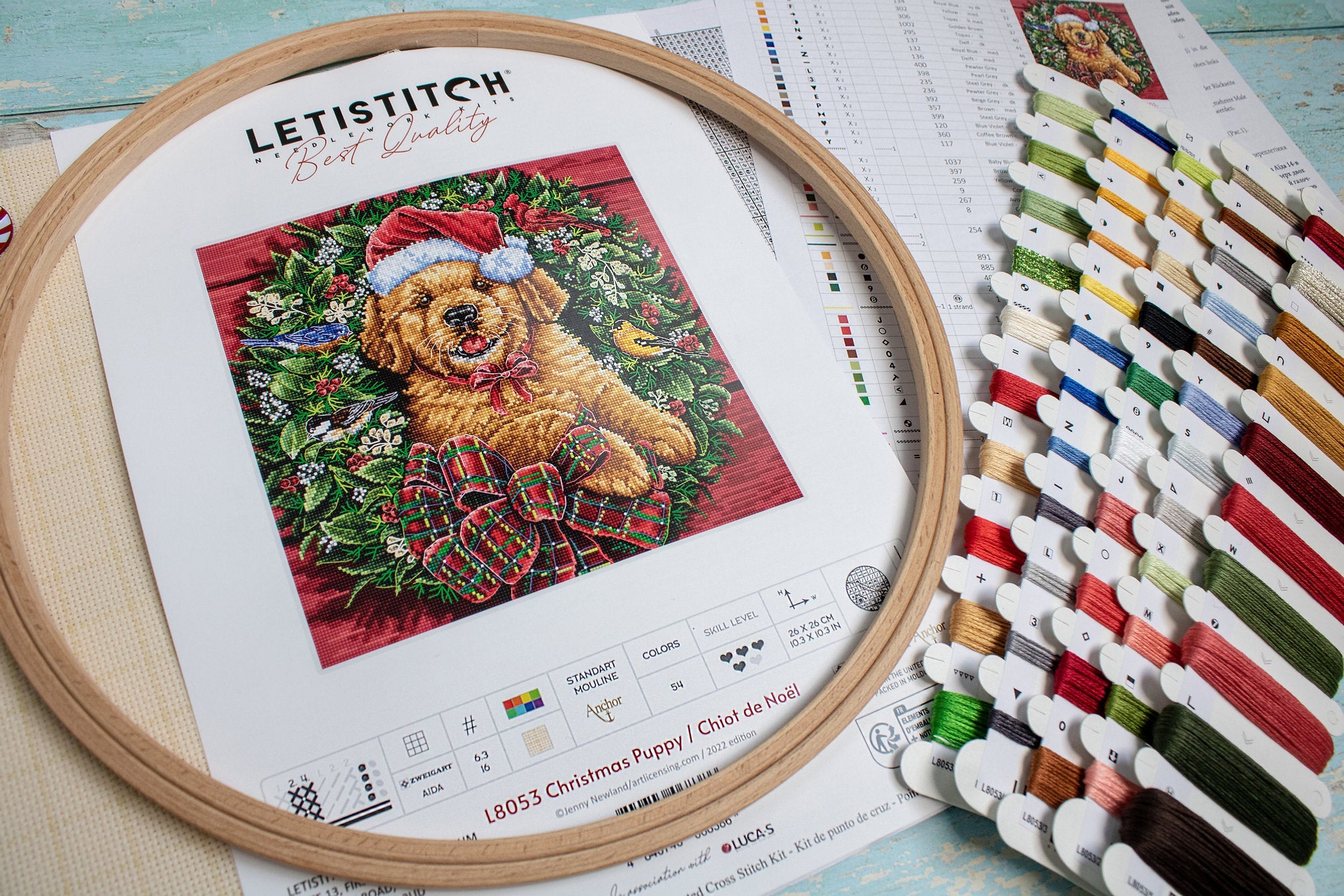 Christmas Puppy Counted Cross Stitch Kit featuring a festive design with 54 colors, needle, and instructions on 16-count Aida canvas.