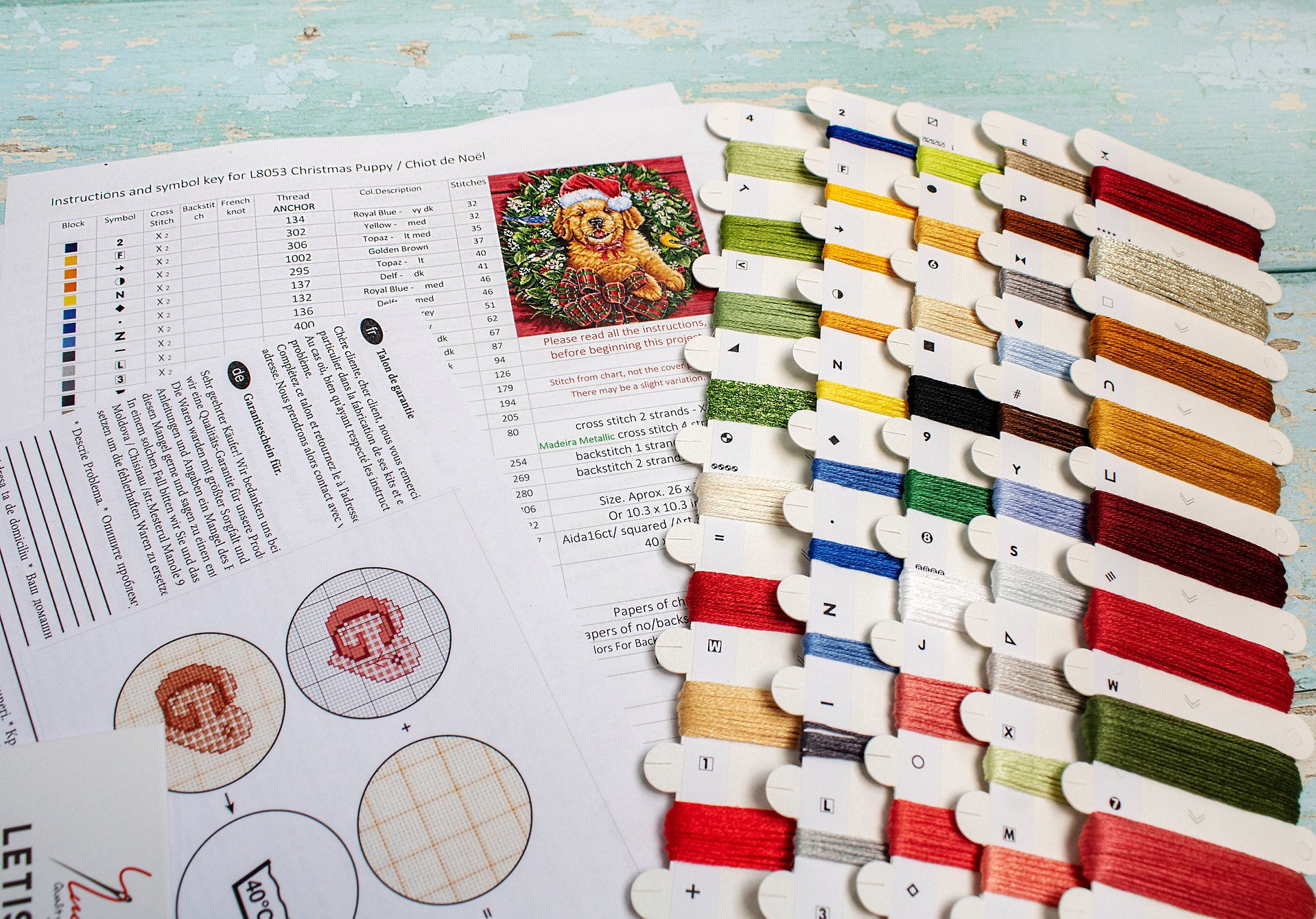 Christmas Puppy Counted Cross Stitch Kit featuring a festive design with 54 colors, needle, and instructions on 16-count Aida canvas.