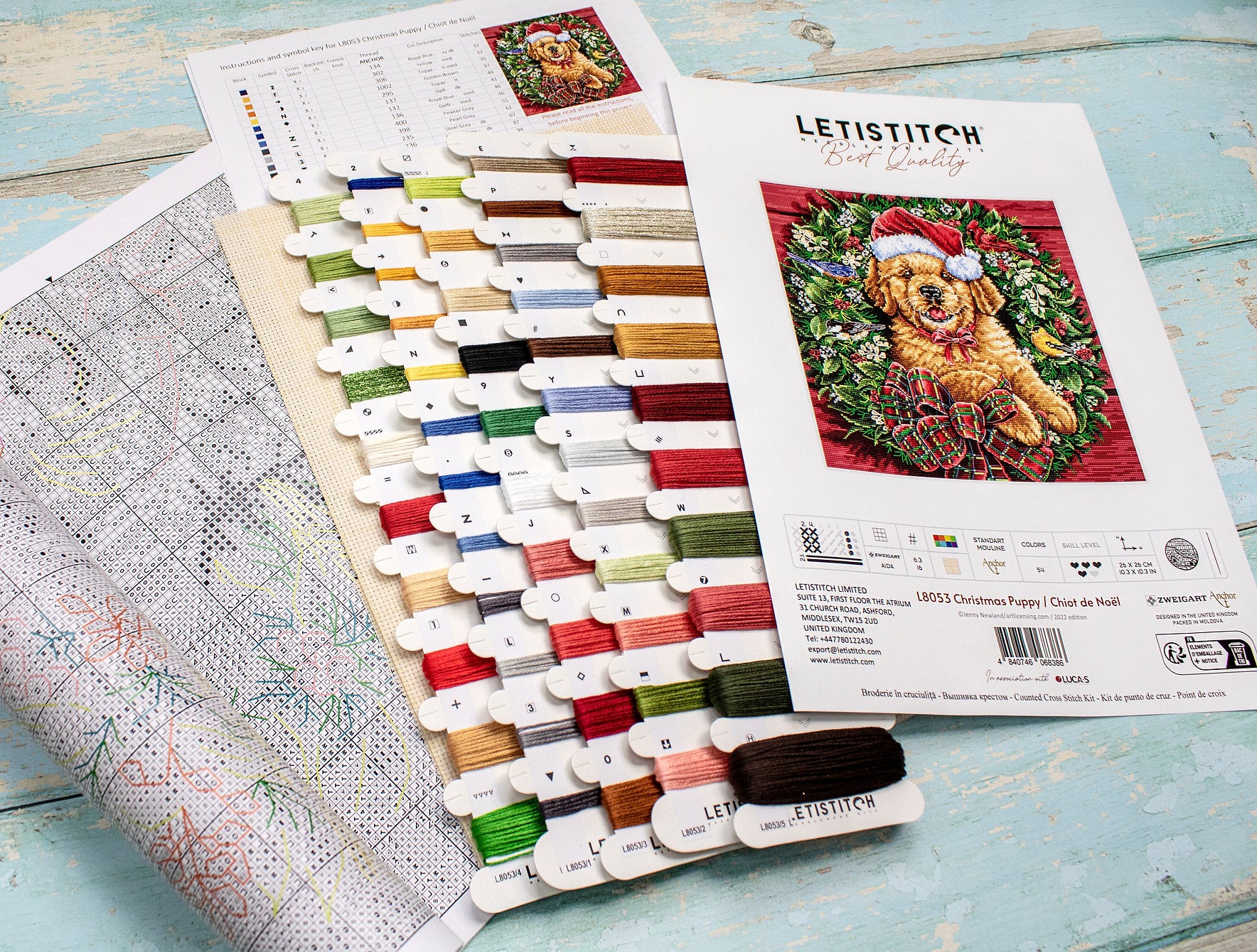 Christmas Puppy Counted Cross Stitch Kit featuring a festive design with 54 colors, needle, and instructions on 16-count Aida canvas.