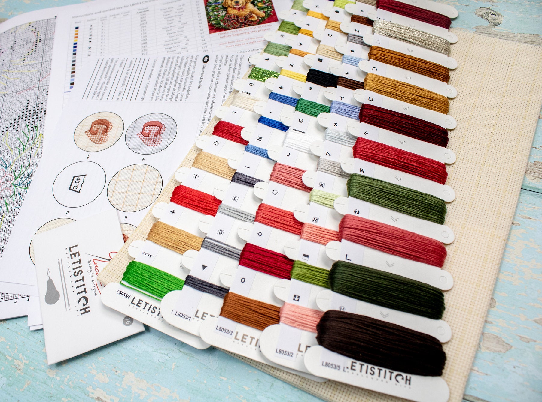 Christmas Puppy Counted Cross Stitch Kit featuring a festive design with 54 colors, needle, and instructions on 16-count Aida canvas.