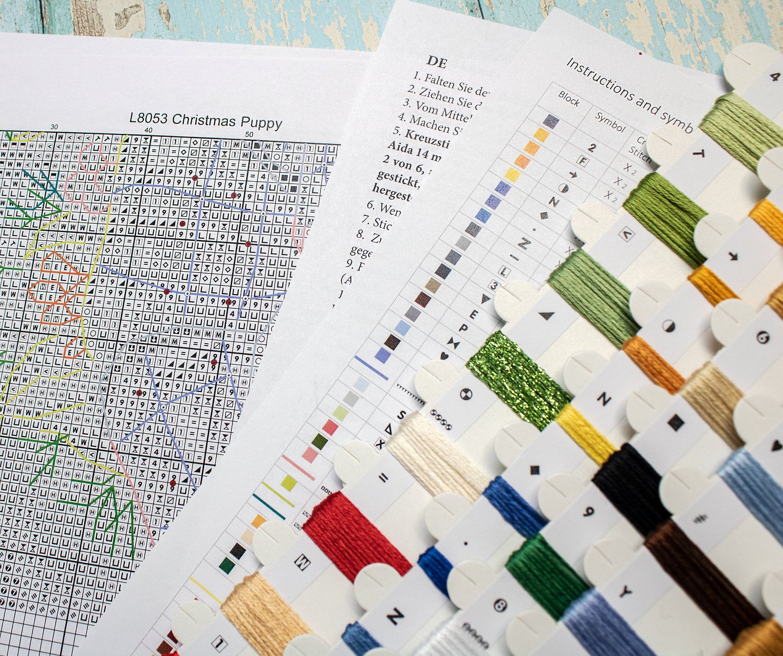 Christmas Puppy Counted Cross Stitch Kit featuring a festive design with 54 colors, needle, and instructions on 16-count Aida canvas.