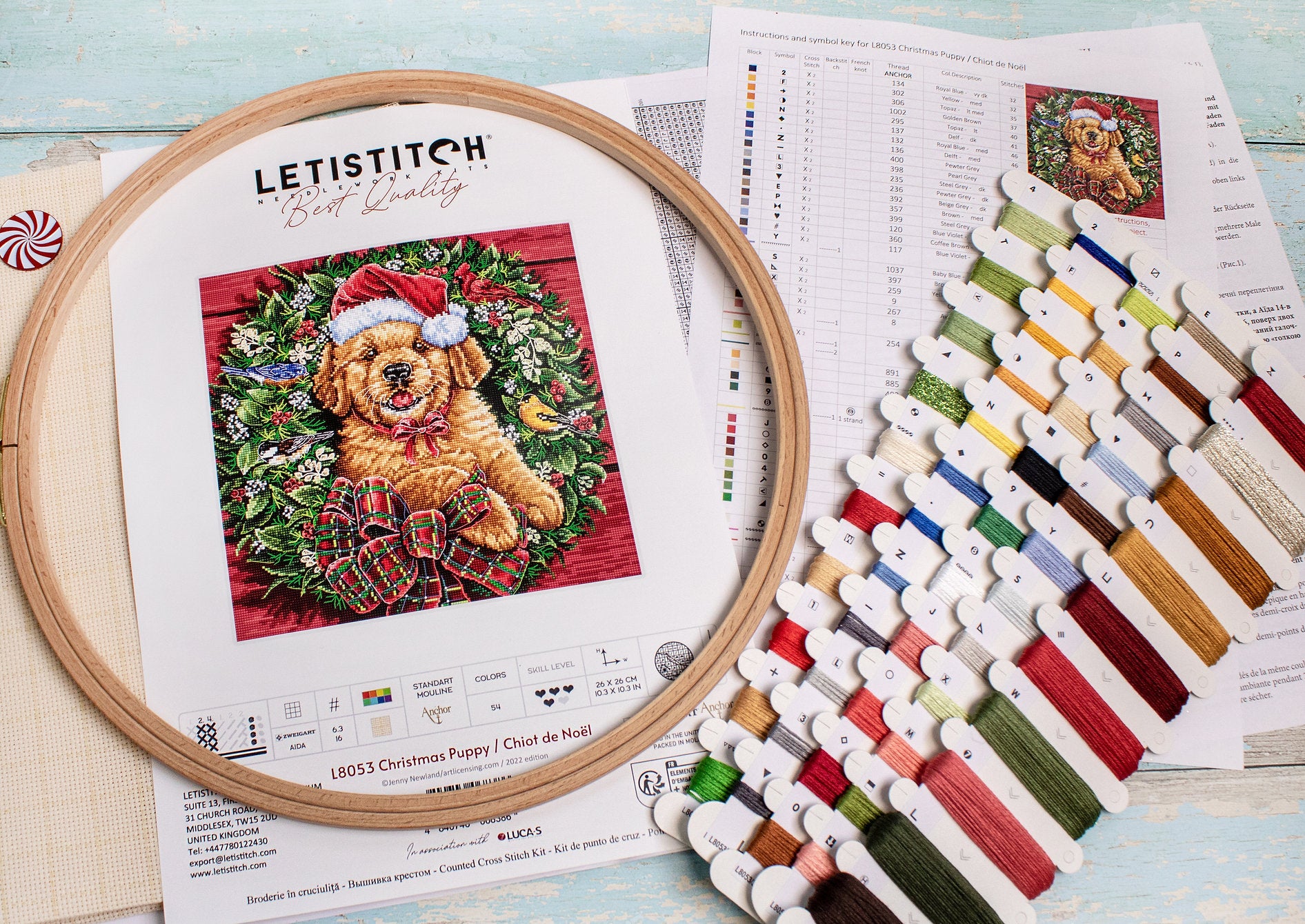 Christmas Puppy Counted Cross Stitch Kit featuring a festive design with 54 colors, needle, and instructions on 16-count Aida canvas.