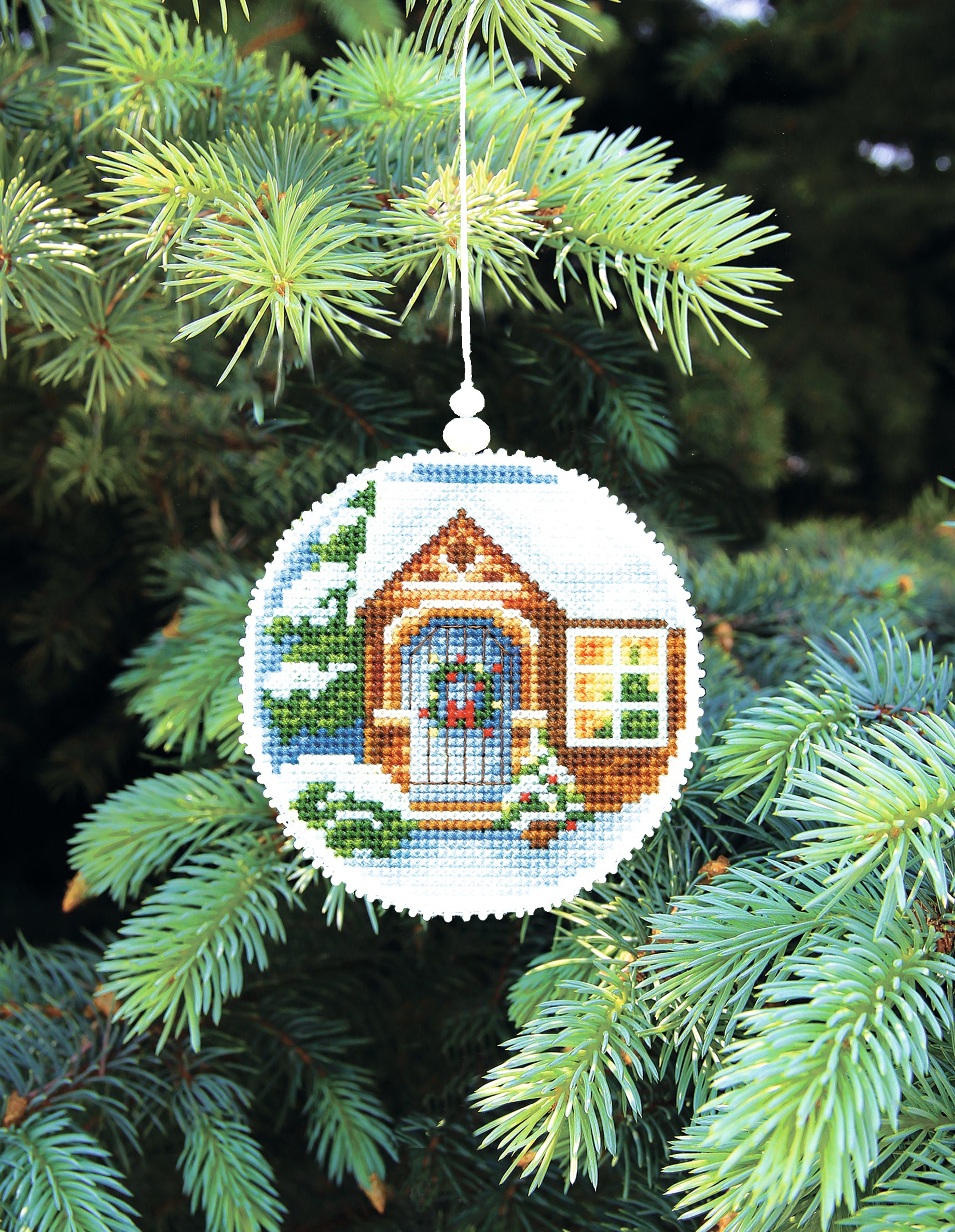 Christmas tree toy cross-stitch kit featuring plastic canvas, colorful Madeira cotton floss, and Preciosa Ornela beads, perfect for winter crafting.