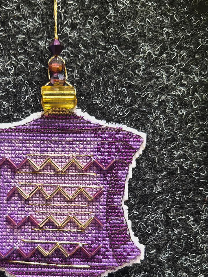 Colorful Christmas tree toy plastic canvas cross-stitch kit with vibrant materials and detailed instructions.