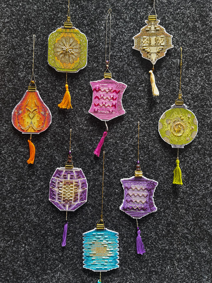 Colorful Christmas tree toy plastic canvas cross-stitch kit with vibrant materials and detailed instructions.