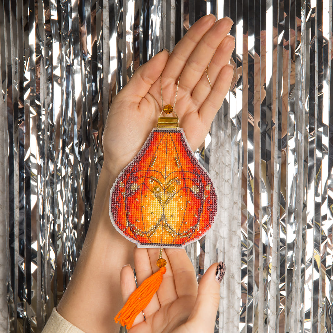 Colorful Christmas tree toy cross-stitch kit with vibrant materials including cotton floss and beads.