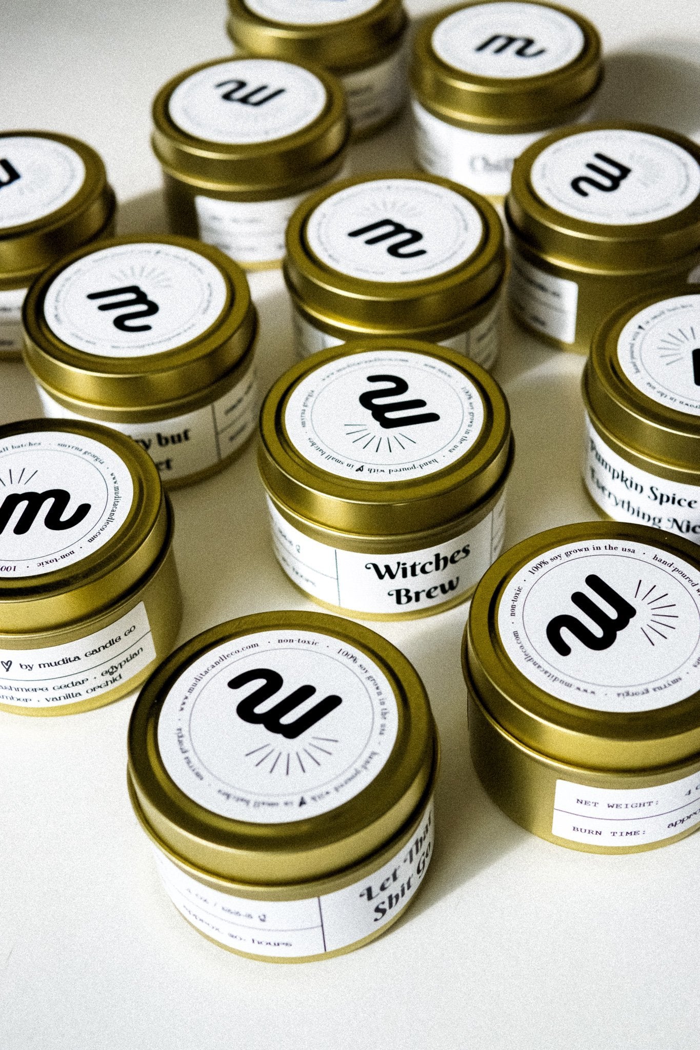 Gold travel candle featuring a blend of cinnamon, fir needles, clove, and vanilla in a stylish tin jar.