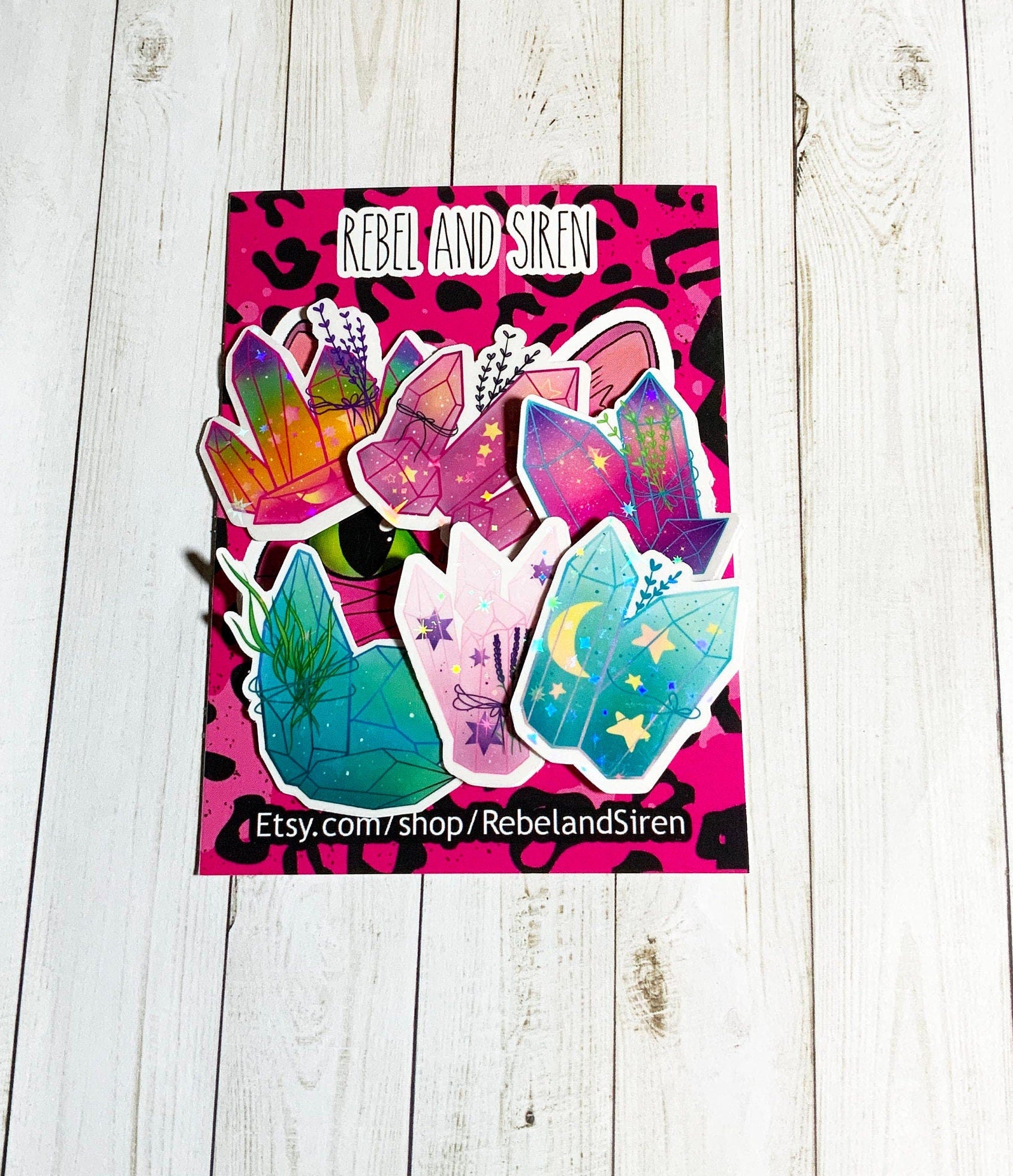 A vibrant pack of colorful crystal stickers featuring six unique designs on matte vinyl, showcasing their glossy laminated finish.