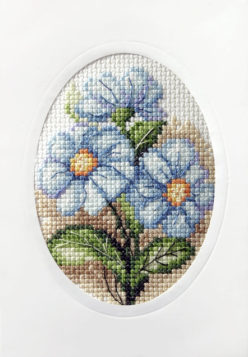 Complete cross stitch kit featuring blue flowers design, includes fabric, threads, card, envelope, and needle.