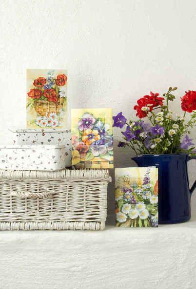 Complete cross stitch kit featuring a Pansies design, including fabric, threads, card, and instructions.