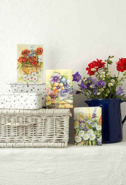 Complete cross stitch kit featuring a Pansies design, including fabric, threads, card, and instructions.