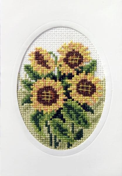 Complete cross stitch kit featuring sunflowers, including Zweigart aida fabric, DMC threads, blank card, envelope, and needle.