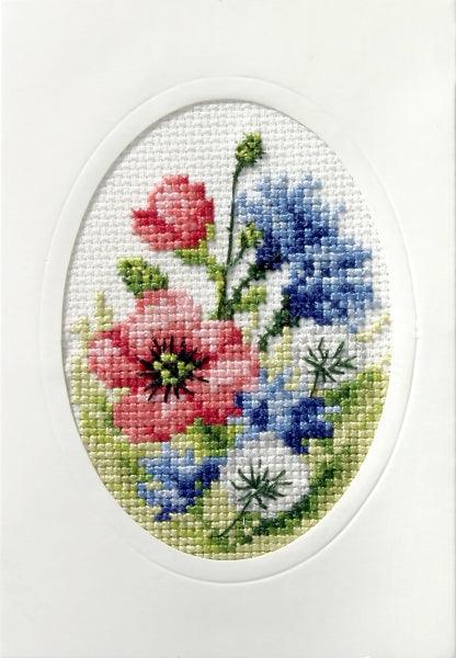 Complete cross stitch kit featuring 'Wild Flowers' design, including Zweigart aida fabric, DMC threads, blank card, envelope, and needle.