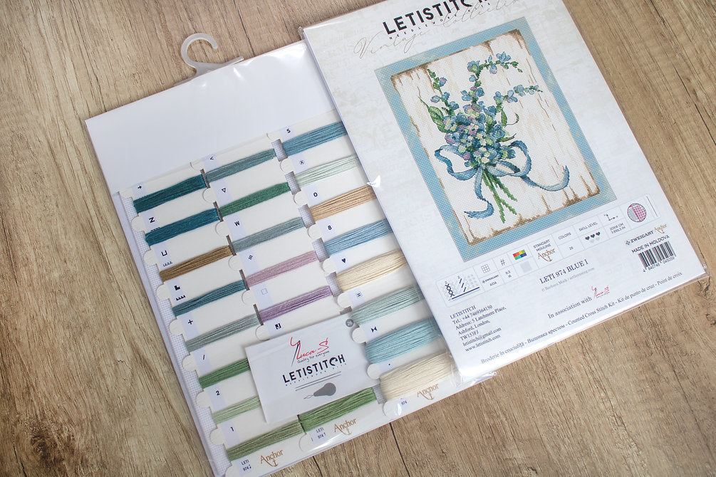 Counted Cross Stitch Kit BLUE I Leti974 featuring vibrant Anchor threads, canvas, needle, and instructions for crafting.