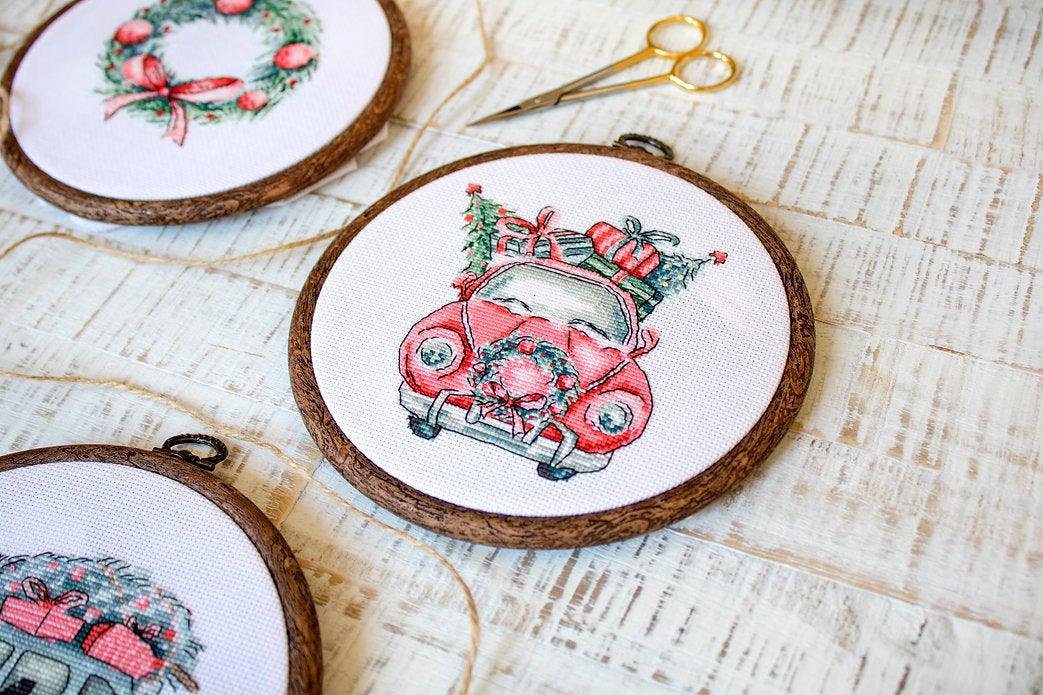 Counted Cross Stitch Kit featuring Christmas Retro Cars with colorful threads and canvas, perfect for holiday crafting.