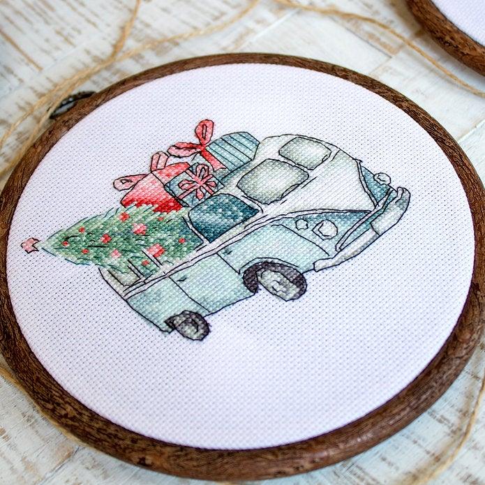 Counted Cross Stitch Kit featuring Christmas Retro Cars with colorful threads and canvas, perfect for holiday crafting.